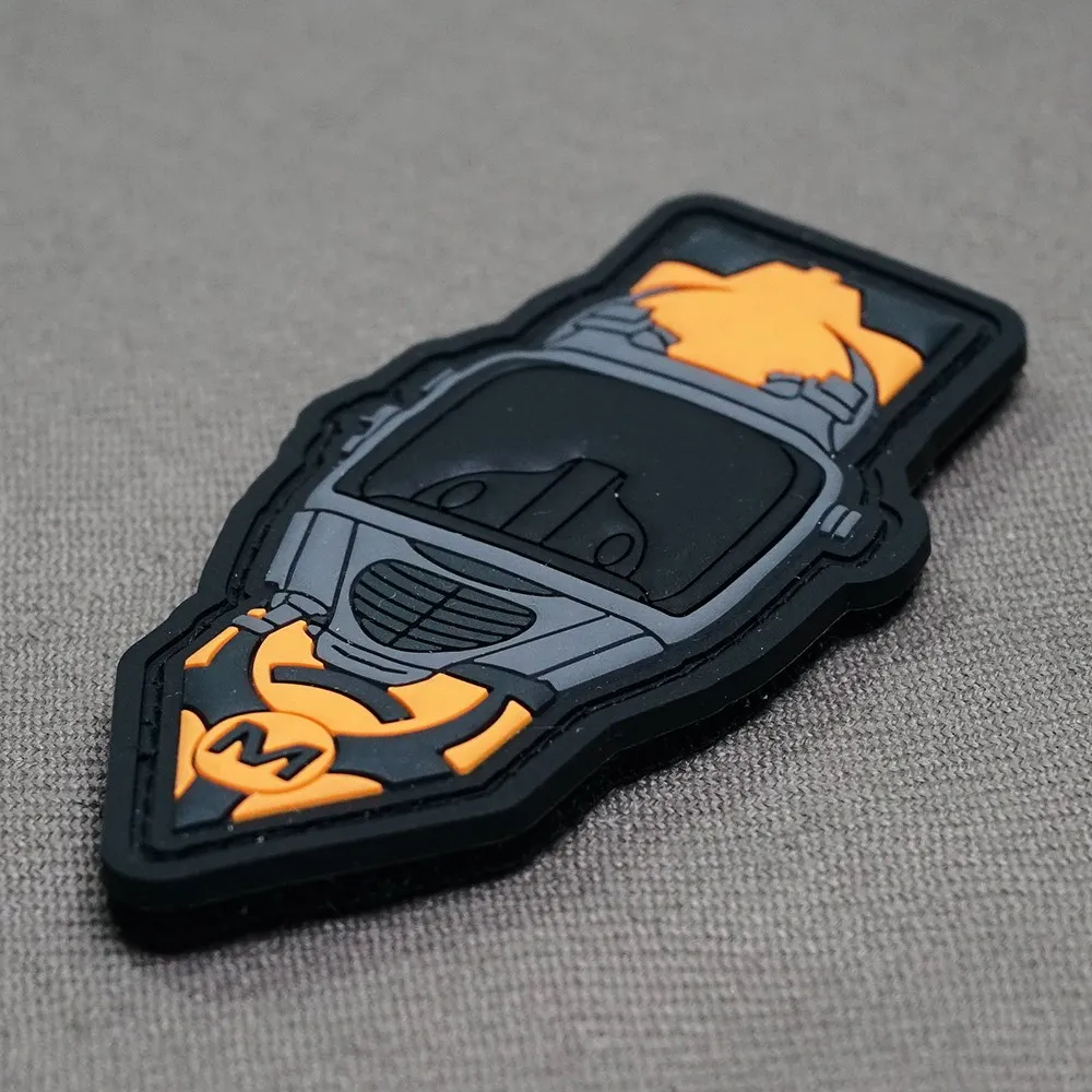 Black and orange PVC patch photographed from the side to show relief