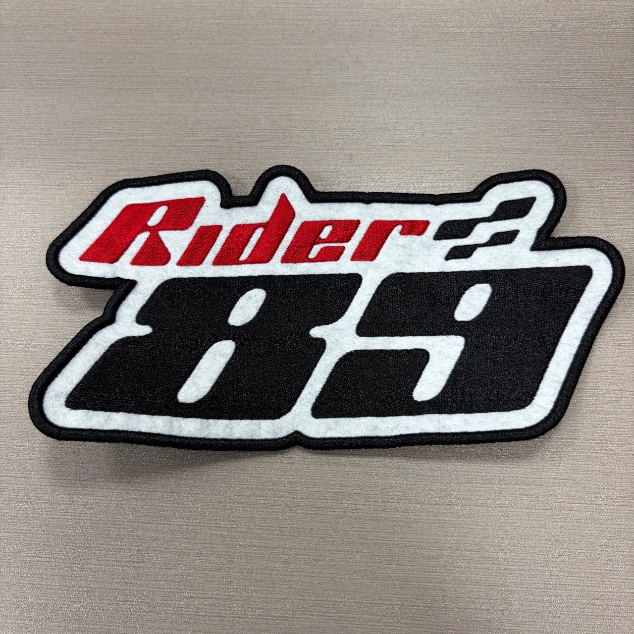 Custom shaped red black and white woven patch