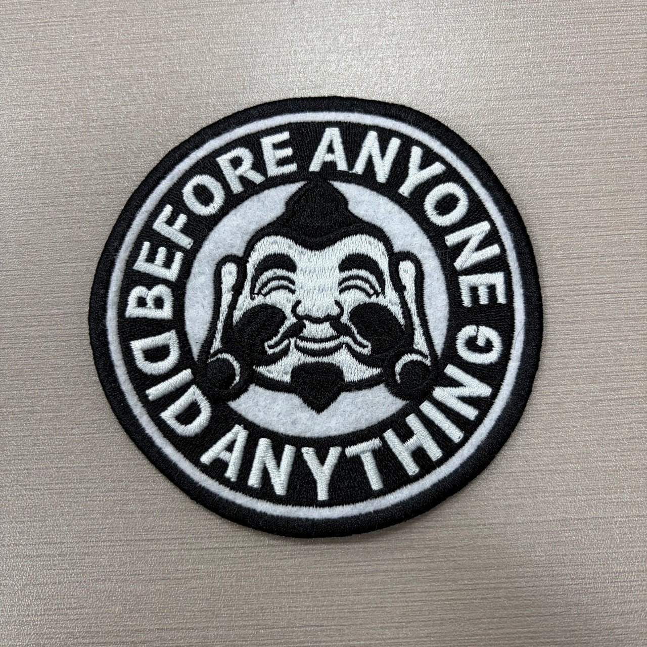 Black and white circular woven patch with detailed lettering