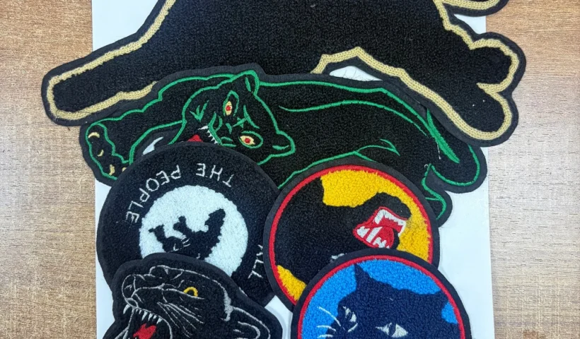 A close-up view showing exactly what is a chenille patch with its fuzzy yarn texture.