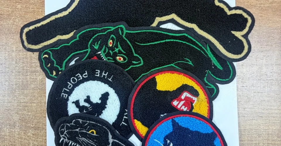 A close-up view showing exactly what is a chenille patch with its fuzzy yarn texture.