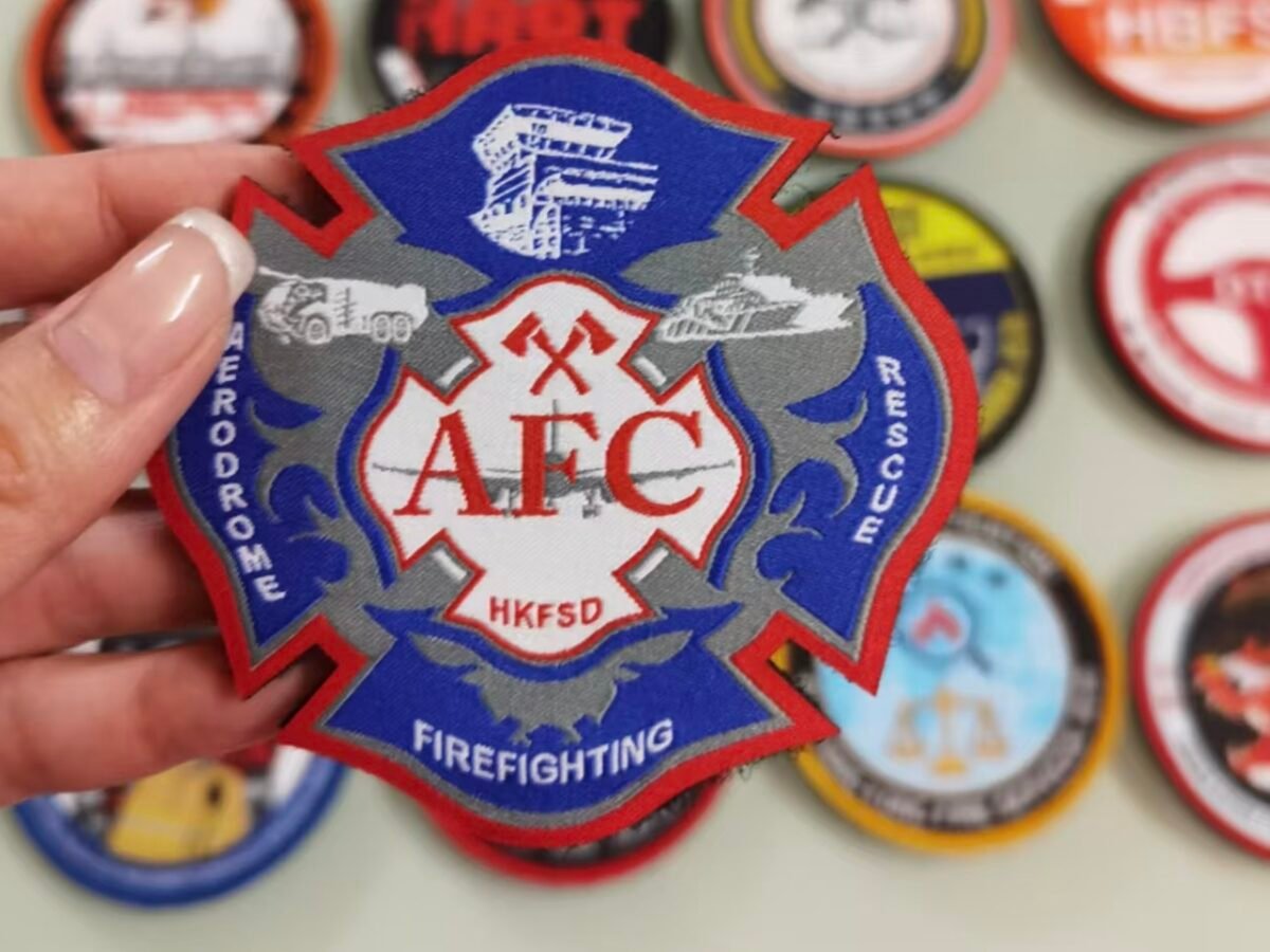 Custom fire department patches with an AFC firefighting emblem held in front of other patch designs