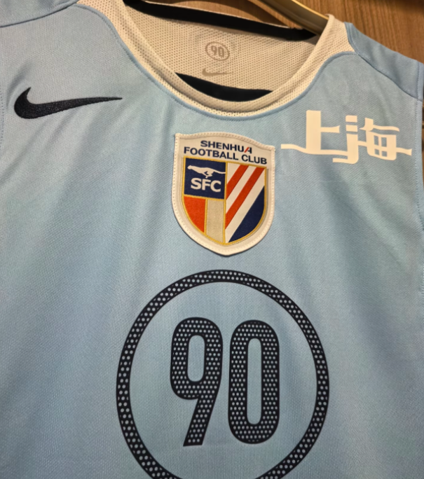 Custom vest patches placement reference showing a shield-shaped football crest on light-blue sportswear