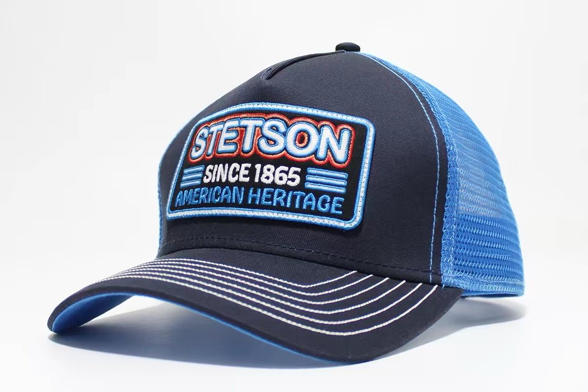 Navy trucker hat with blue mesh and a blue-bordered rectangular lettering patch
