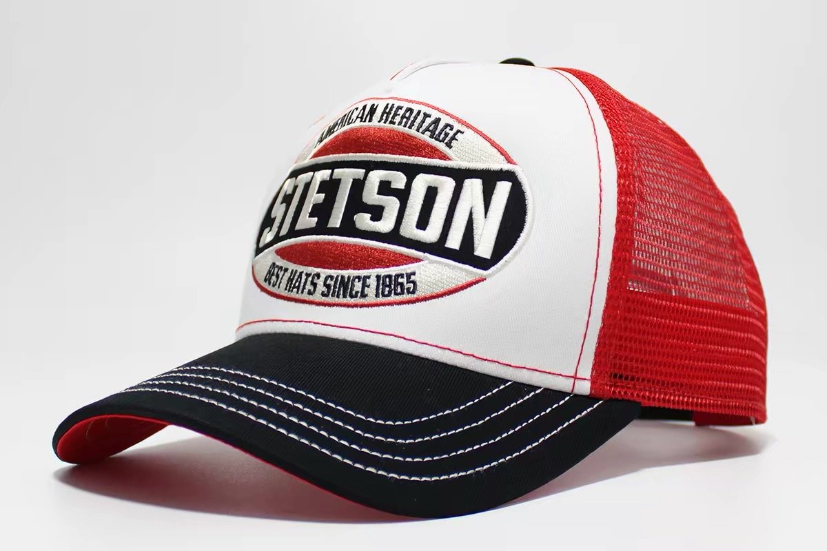 White-front trucker hat with red mesh, black brim and a red white and black oval badge