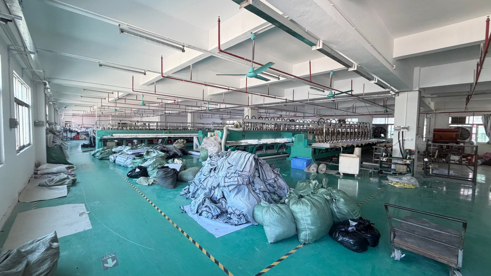 Embroidery machines and textile materials inside the PatchCraftPro factory in Humen, Dongguan