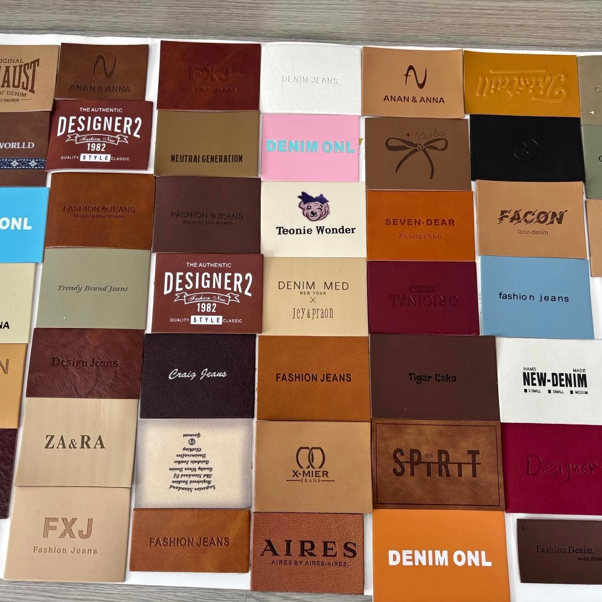 Assorted custom leather patches in tan, brown and colored finishes with different logo designs