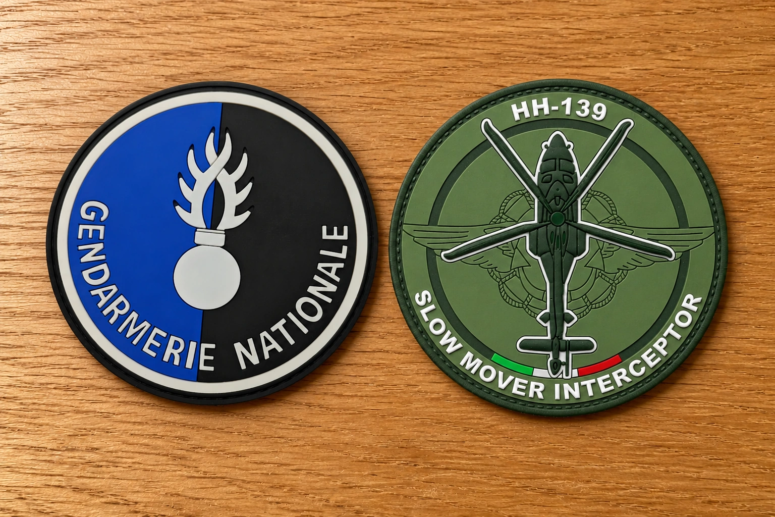 A flat 2D PVC patch on the left and a sculpted 3D PVC helicopter patch on the right, placed on a wooden tabletop.